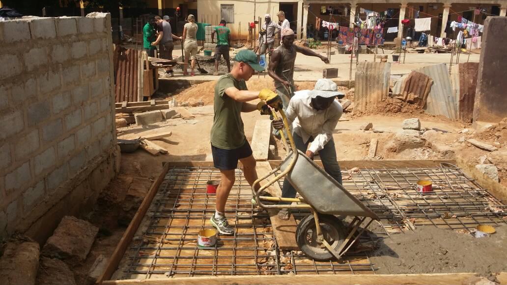 A volunteer helps lay the foundations of a toilet block whilst on building volunteering work in Ghana with Projects Abroad. A volunteer is pictured laying the foundations for a toilet block as part of his building volunteer work in Ghana.